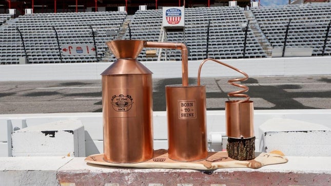 A bronze moonshine trophy still has the inscription "Born to shine" and bears the NASCAR All-Star race emblem.